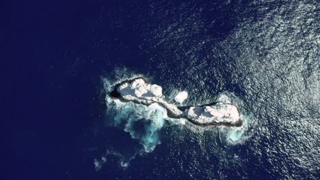 Top-down-aerial-view-of-white-guano-Roca-Partida-islet-in-azure-Mexican-Pacific