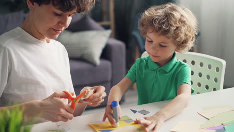 mother and son doing arts and crafts at home