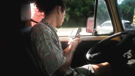 Hispanic driver paying on toll road