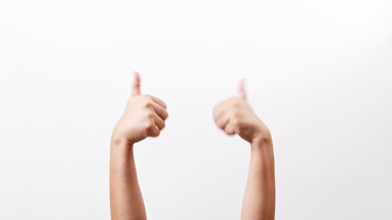 Close up of Woman's hands showing and making thumb up sign isolated on a white studio background with copy space for place a text, message for advertisement and product promotional.