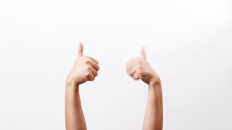 close up of woman's hands showing and making thumb up sign isolated on a white studio background with copy space for place a text, message for advertisement and product promotional.