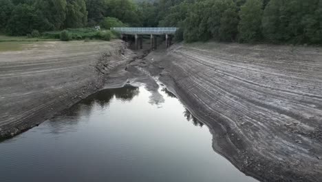 Aerial-drone-flight-over-and-around-Errwood-Reservior-in-Goyt-Valley-Buxton-UK-showing-very-low-water-levels-during-the-heatwave-2022