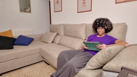 a person using a tablet on a couch