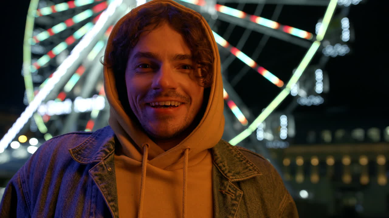 Surprised man felling happy in city center. Amazed guy looking camera on street.