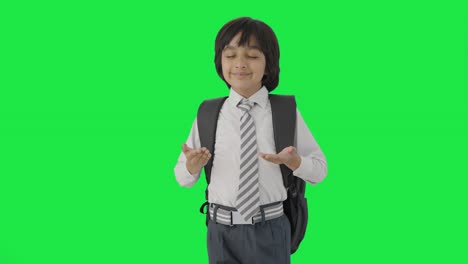 Happy-Indian-school-boy-doing-breathe-in-breathe-out-exercise-Green-screen