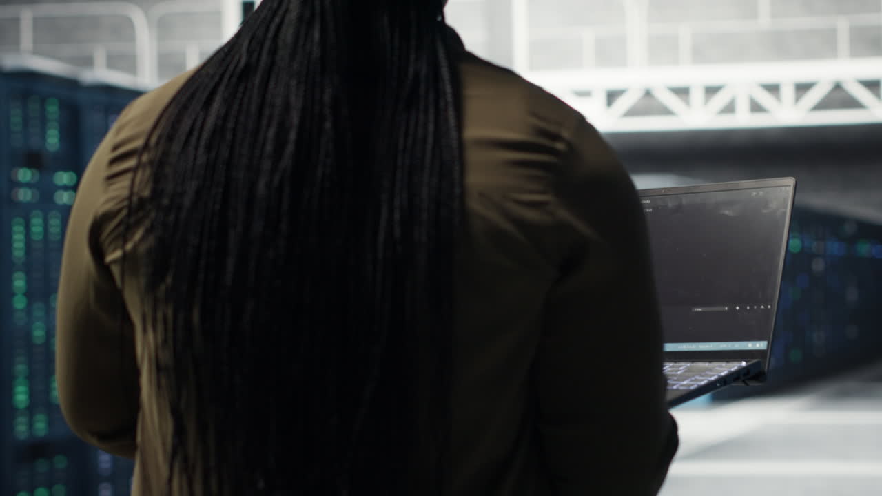 Computer scientist doing data center automation using AI on laptop