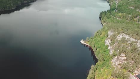 sideways movement of a drone shot over a lake surrounded by a forest