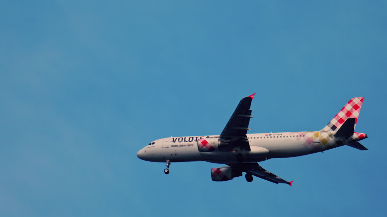 Antibes, France - April 4, 2025: View of a Volotea airplane flying in the blue sky