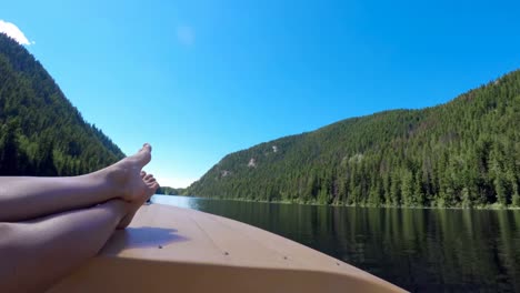 woman relaxing with feet up in boat 4k