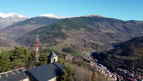 drone shot flying over sant antoni church in ribes de freser, pyrenees mountains