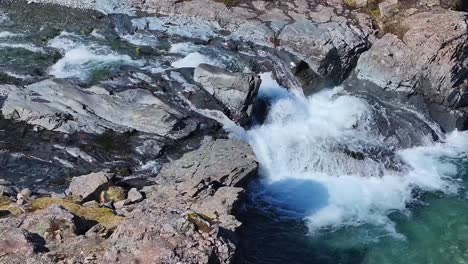 the gentle flow of water over river rocks creates a soothing melody, enveloped in a tranquil shade of serenity, waterfall skutafoss