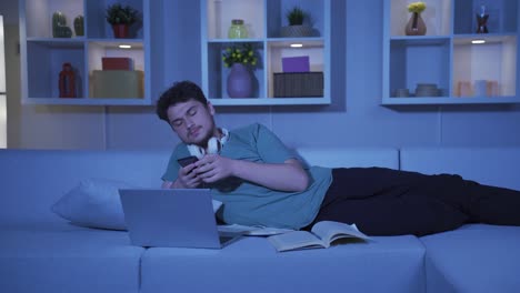 depressed man at night texting on the phone.