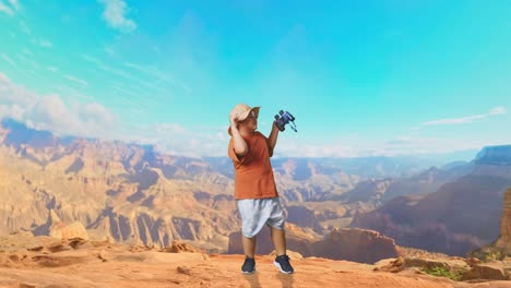 asian boy with a hat holding binoculars and dancing. boy researcher examines something while traveling at the top of mountain, travel tourism adventure concept, full body