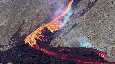 magma resplandeciente que fluye hacia abajo después de la erupción volcánica fagradalsfjall en islandia