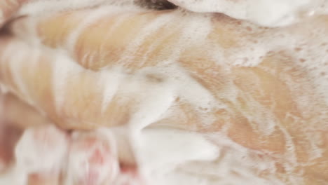 male caucasian washes hands thoroughly, high angle close up shot