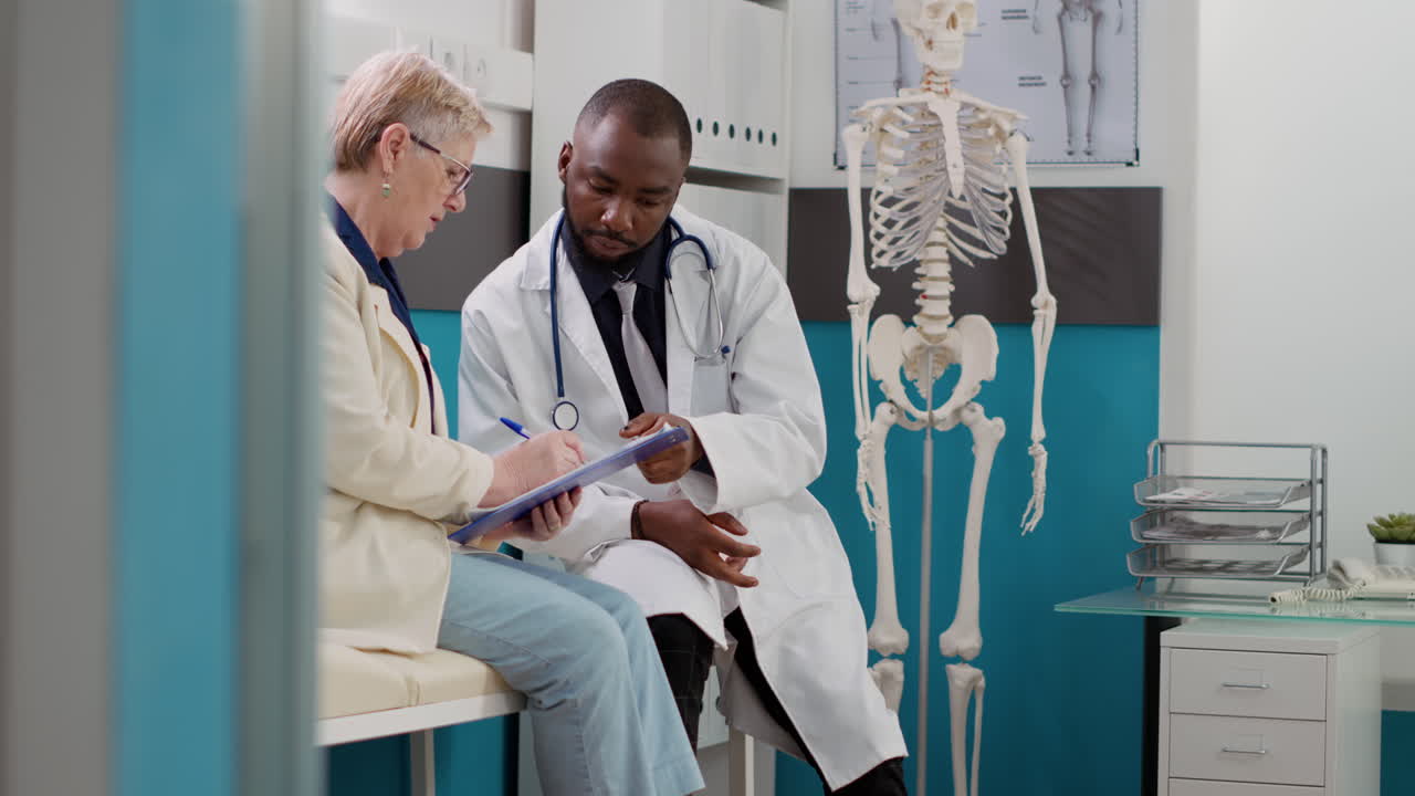 Doctor consulting with elderly patient in clinic