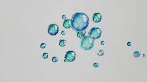 aerial view of floating blue and green bubbles on a white background, creating a serene and abstract