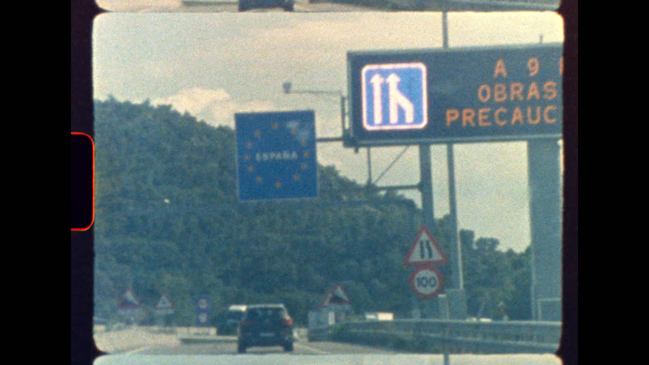 Crossing border into Spain on a retro highway with vintage road signs