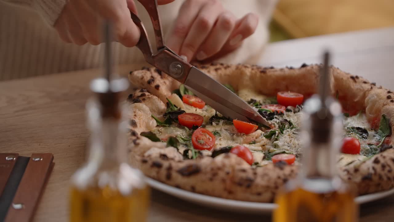 Woman Cutting a Delicious Homemade Pizza
