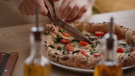 woman cutting a delicious homemade pizza