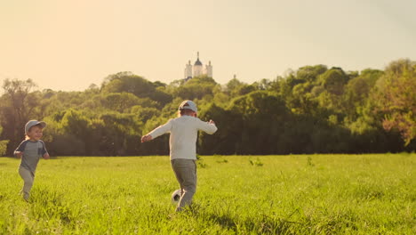 The-boy-runs-with-a-soccer-ball-laughing-at-the-sunset-in-slow-motion.