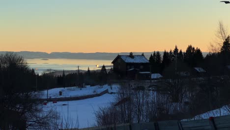inner oslo fjord sunset norway norge aerial drone norwegian frognersteteren restaurant cabin lodge skimore oslo holmenkollen ski jump cross country ski resort winter sunset forest pan left motion