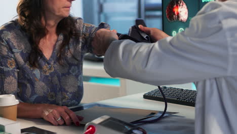 Vertical Video Senior physician measuring blood pressure with a blood pressure monitor