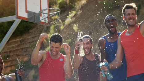 basketball players celebrating by splashing water on each other