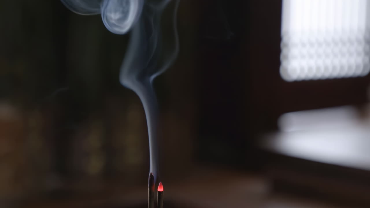Close-Up of Incense Sticks Burning with Rising Smoke