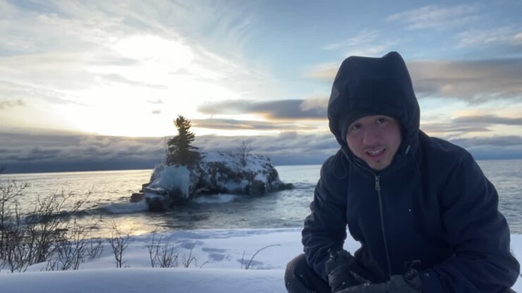 Guy video blogging on the north shore of lake superior minnesota winter time sunrise