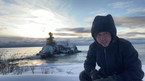 guy video blogging on the north shore of lake superior minnesota winter time sunrise