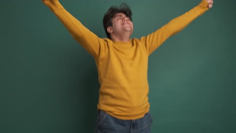 casual young man jumping and dancing celebrating