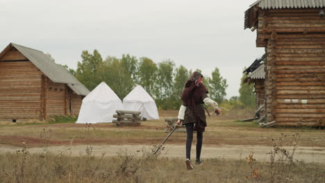 girl rushes to medieval village after sword fighting