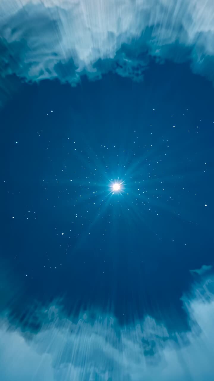 Vertical video: Pulsing star beaming rays, halo radiating in sky, clouds drifting through frames