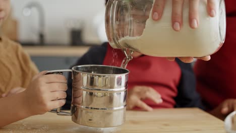 Handheld-video-of-children-helping-mother-with-Christmas-baking