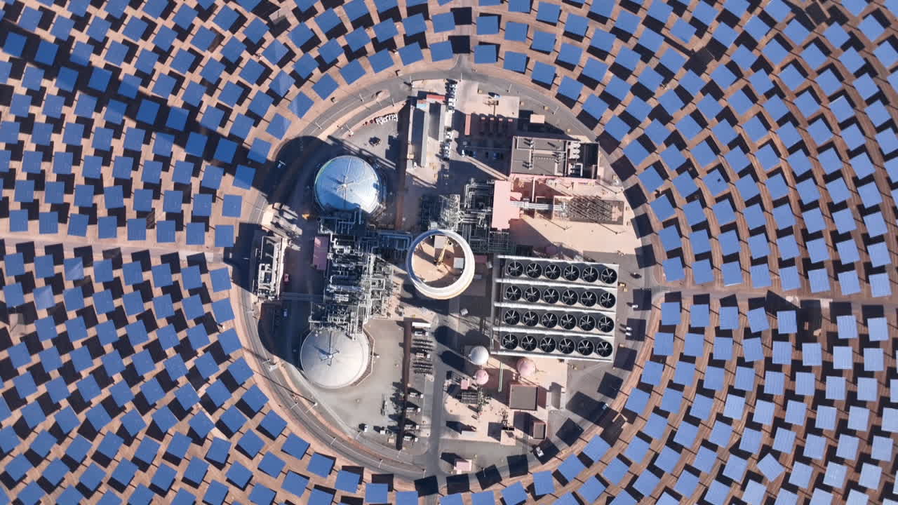 "A sweeping drone shot over Morocco’s Noor Solar Plant, showcasing vast fields of solar panels absorbing sunlight to generate clean, renewable energy."