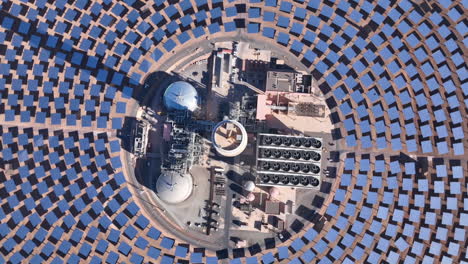 "a sweeping drone shot over morocco’s noor solar plant, showcasing vast fields of solar panels absorbing sunlight to generate clean, renewable energy."