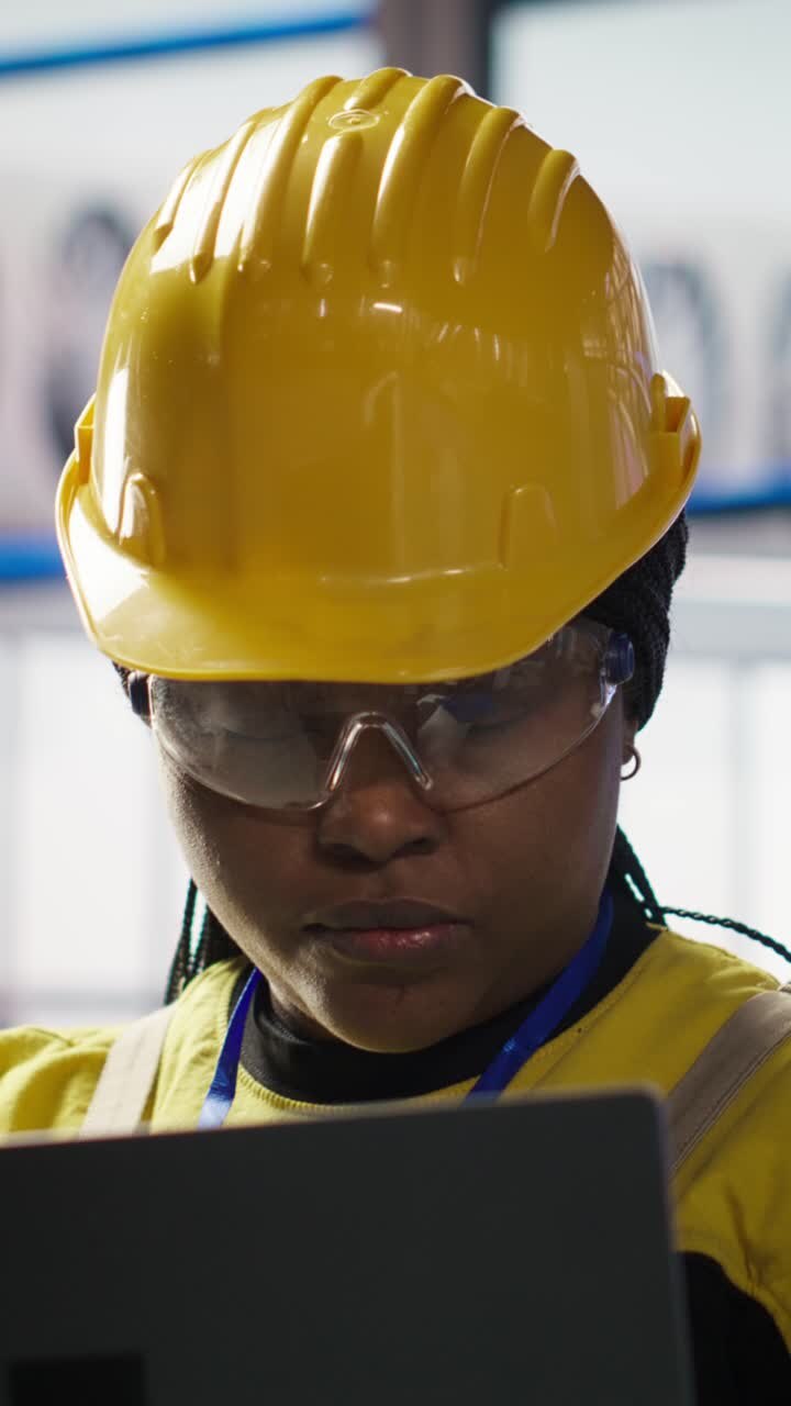 Vertical video Smiling smart factory specialist testing automated systems to ensure reliability
