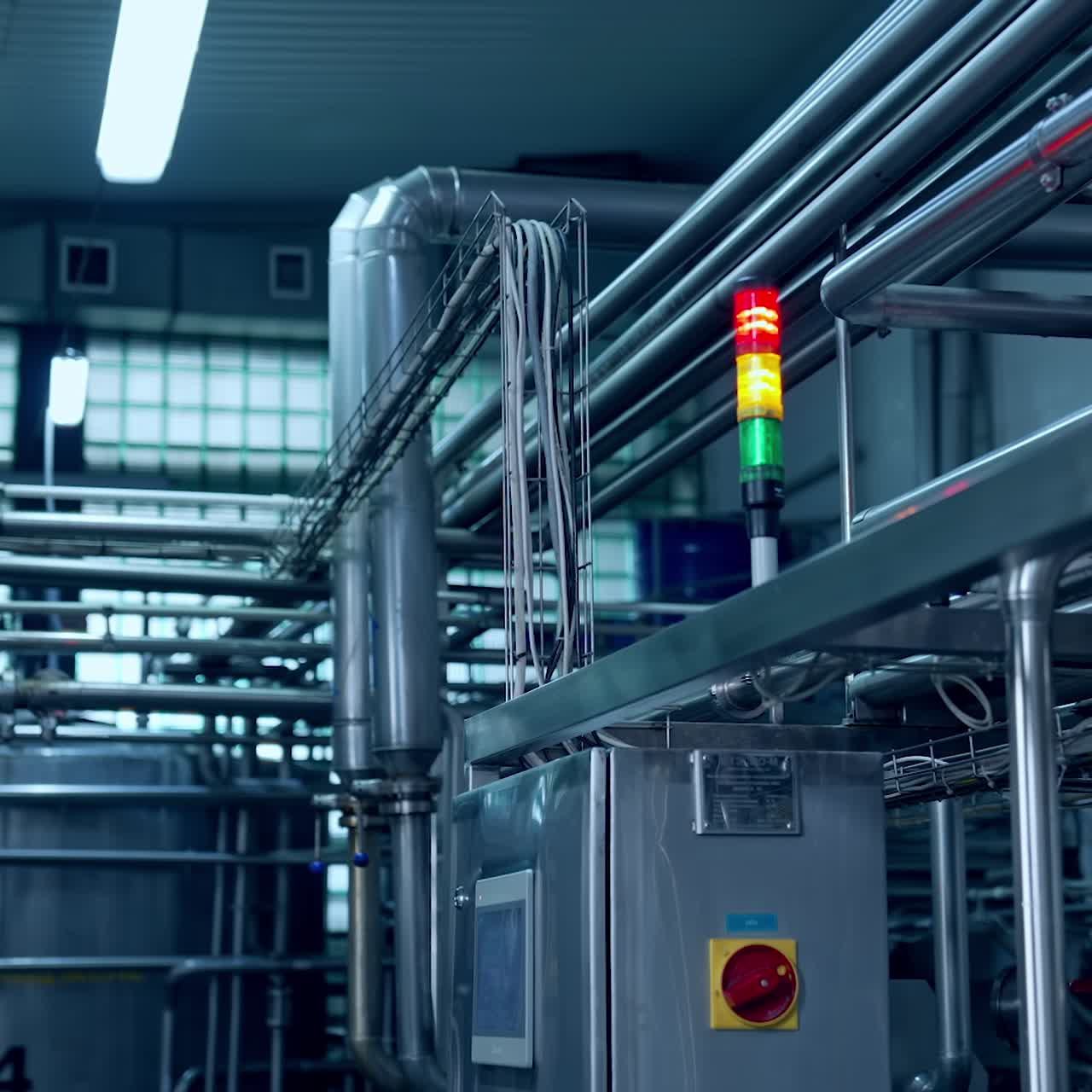 Interior of milk industrial plant. New equipment with metal tubes for production of dairy products. Modern milk factory with automated equipment