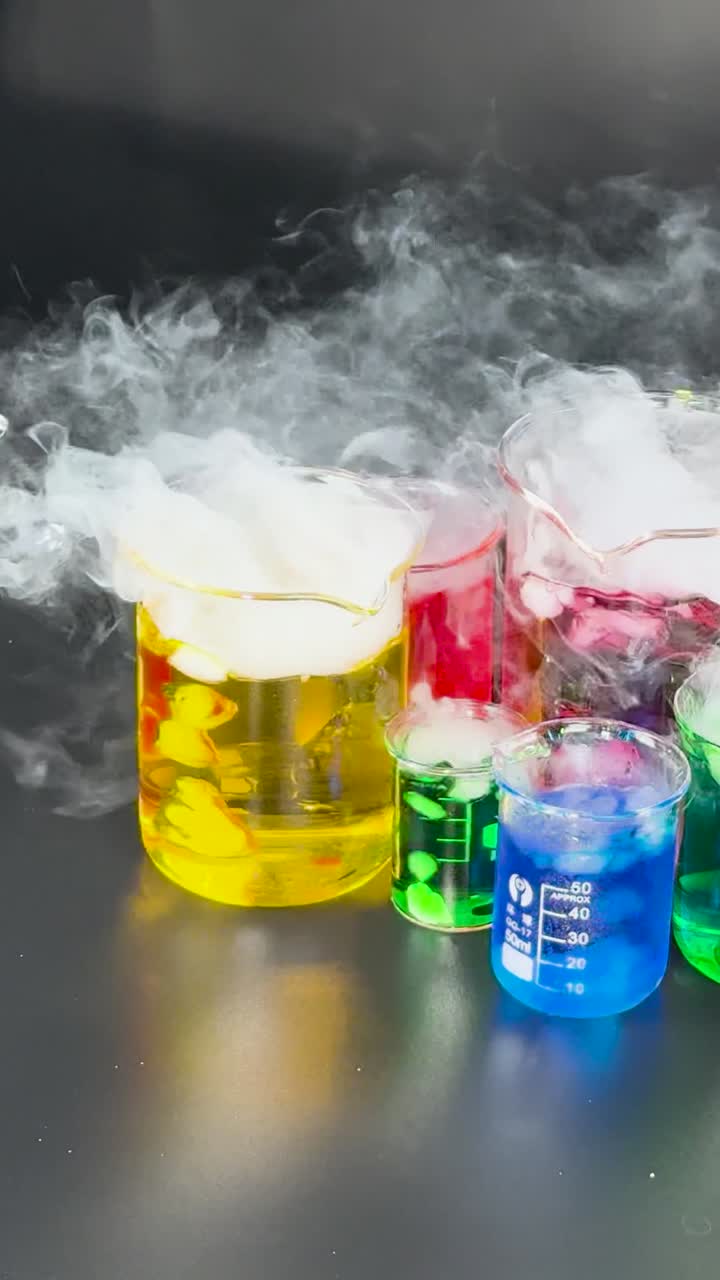 Chemist conducts experiment with colorful liquids and smoke