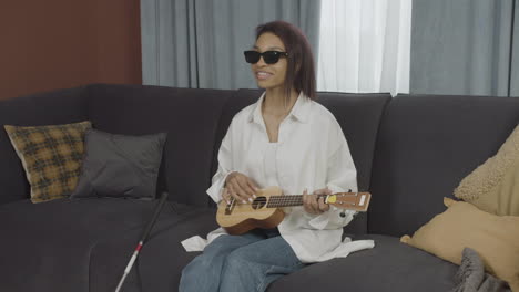 young blind woman sitting on a sofa