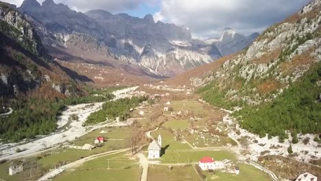 Looking-down-Theth-valley-with-Theth-church-with-the-Albania-alps-in-the-background-at-sunrise