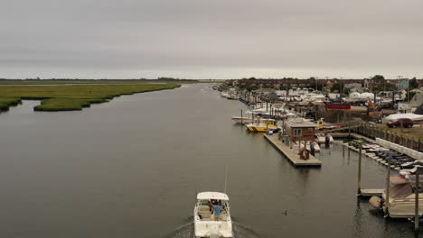 an aerial view of a small fishing boat sailing in a marsh in freeport, ny