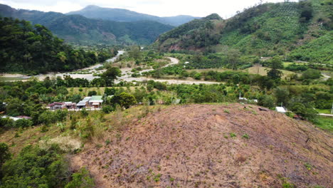 Burned-Patch-of-Land-from-a-Small-Fire-Rotating-Around-with-a-Backdrop-of-Lush-Green-Forest-Trees