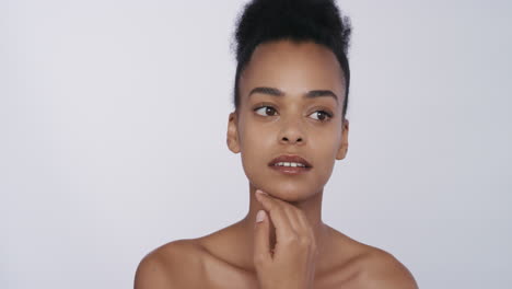 portrait beautiful african american woman touching face with hands caressing smooth healthy skin complexion enjoying perfect natural beauty on white background