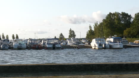 small boats docked at marina in finland, slow panning shot