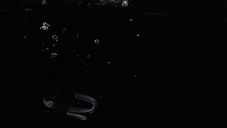 slow motion glasses spin in water after being dropped
