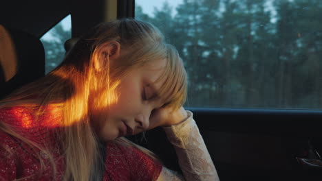 sleepy kid travels in a car long trip
