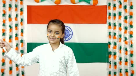 school going little indian girl waving the flag of india - independence day or republic day concept