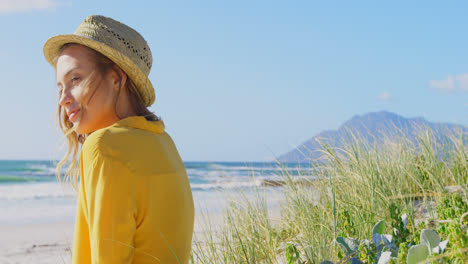 side view of young caucasin woman relaxing on the beach 4k